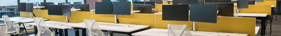 Desks, chairs and computers in an office.