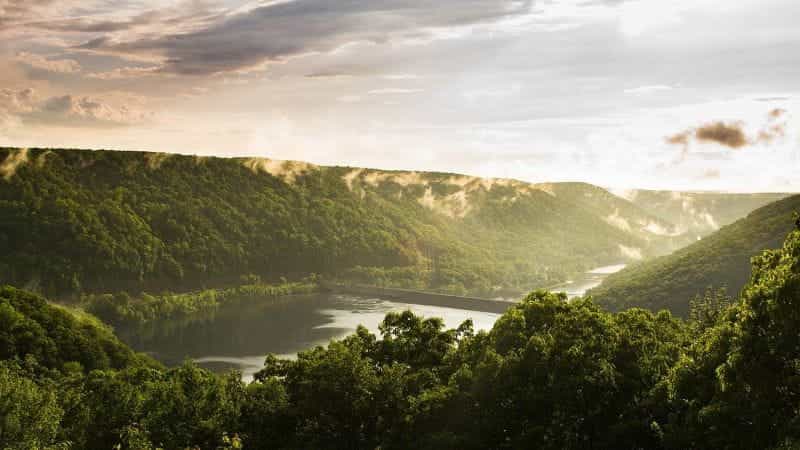 A dam and rolling green hills in rural Pennsylvania.