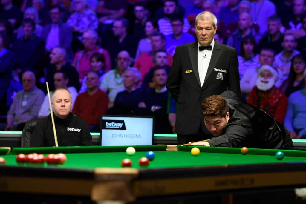 Emerging snooker talent Yan Bingtao playing John Higgins.