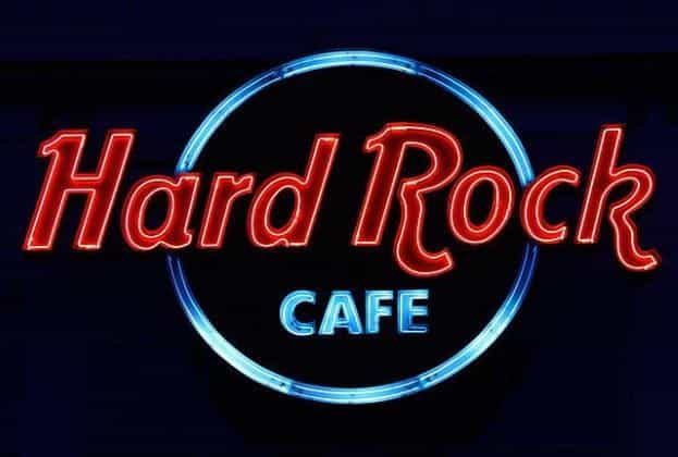 The highly recognizable and world-famous Hard Rock Café sign in red and blue neon lettering.