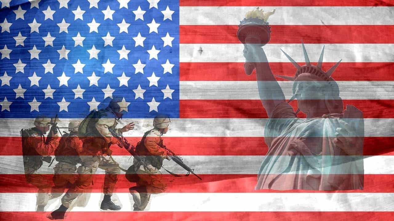 The flag of the United States of America with the Statue of Liberty and several US soldiers in military gear superimposed onto it.