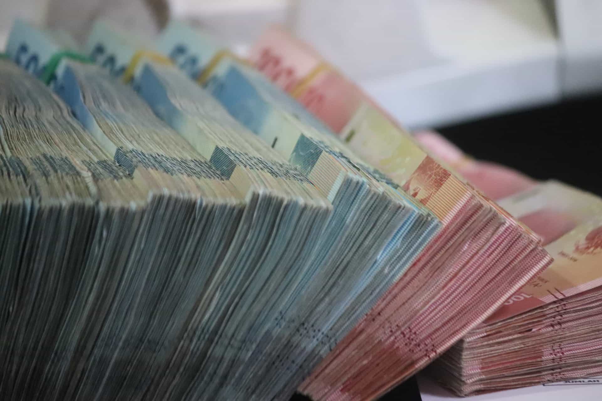 Stacks of money bound together, leaning against each other.