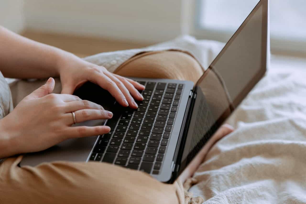 A person typing on a laptop.