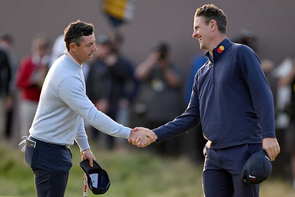 Rory McIlroy shakes hands with Justin Rose on Day One of The 151st Open at Royal Liverpool Golf Club.
