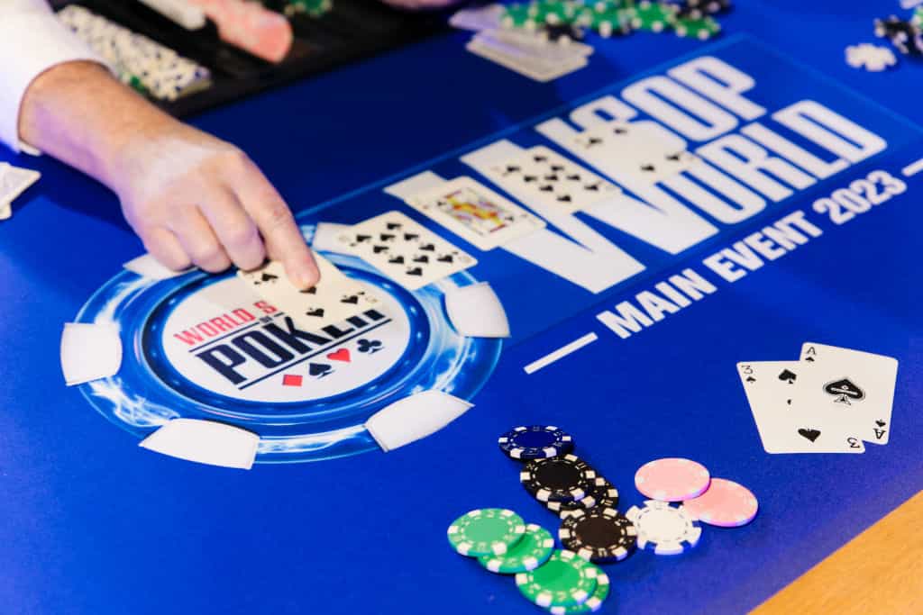 Cards and chips laid out on a 2023 WSOP branded table.