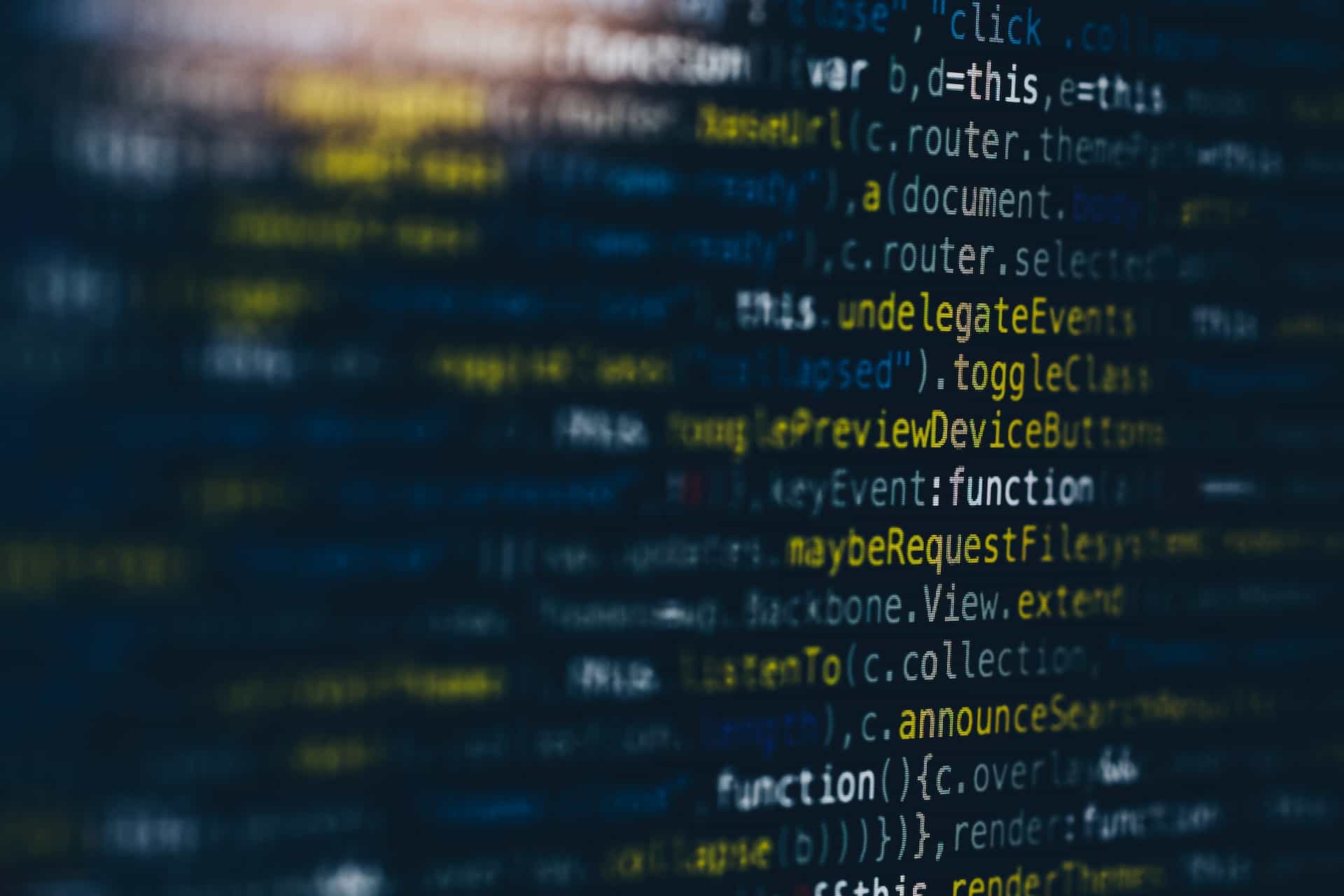 A computer monitor displaying endless rows of a programming language in various colors.