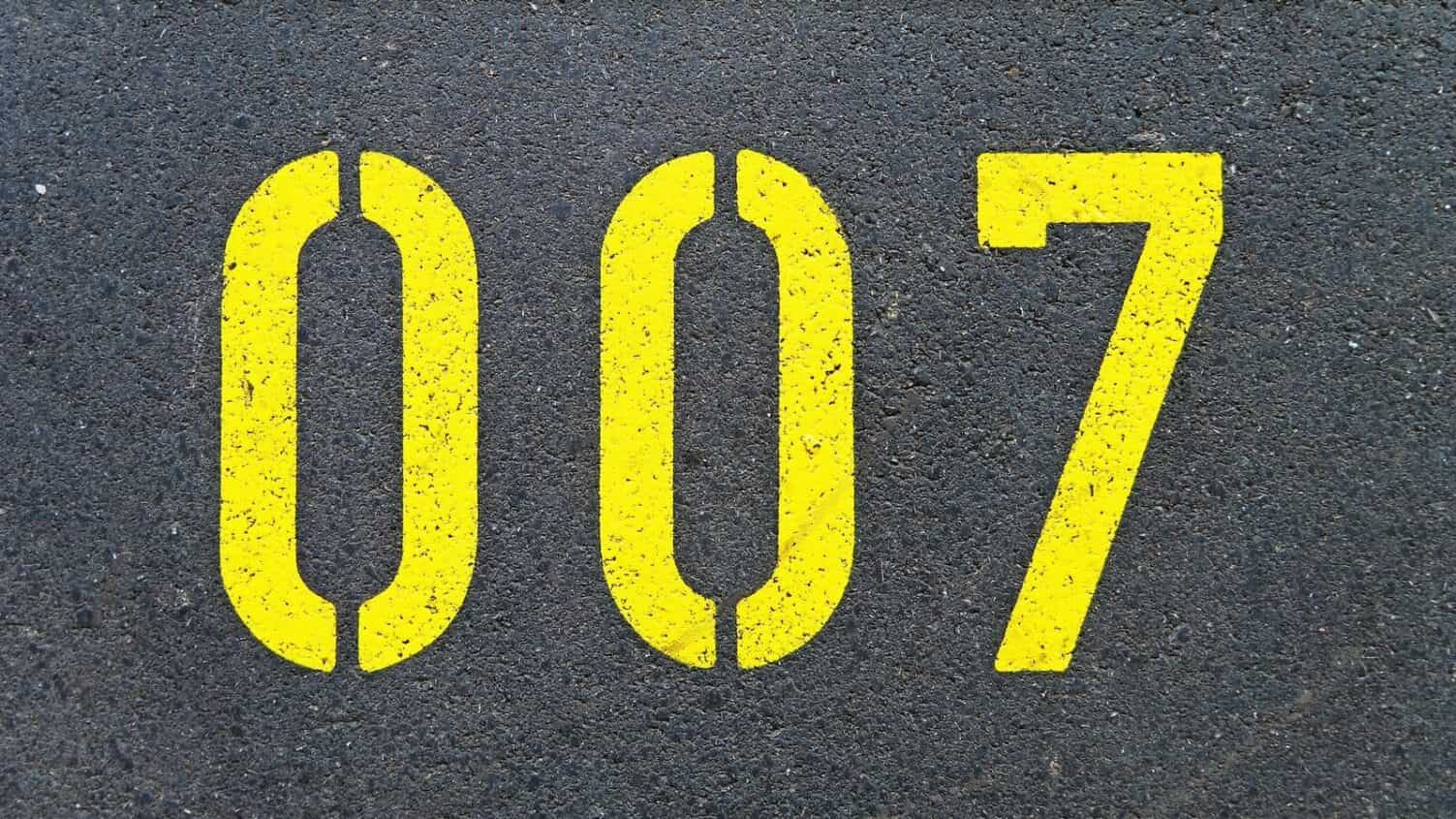 The numbers 007 stenciled onto the pavement in bright yellow paint.