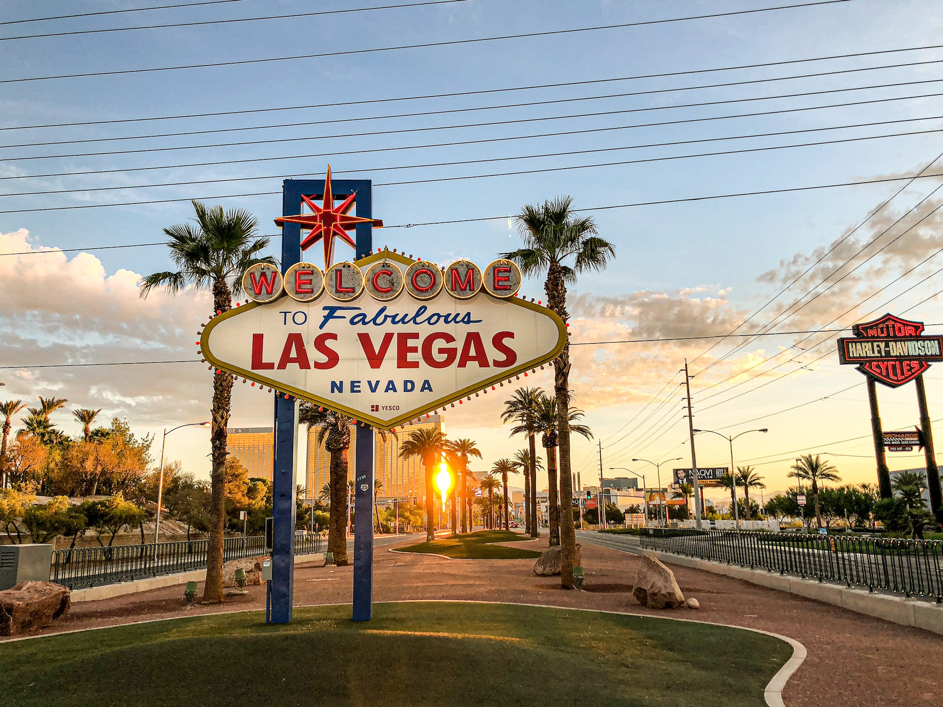 A classic ‘Welcome to Las Vegas’ sign at the entrance to the city, with a prominent Harley Davidson motorcycles sign just off to its right.
